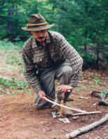 Making fire by friction, demonstration of the bow drill